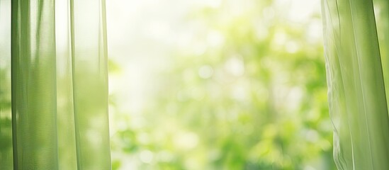 Green garden abstract blur background visible through a window curtain with copy space image