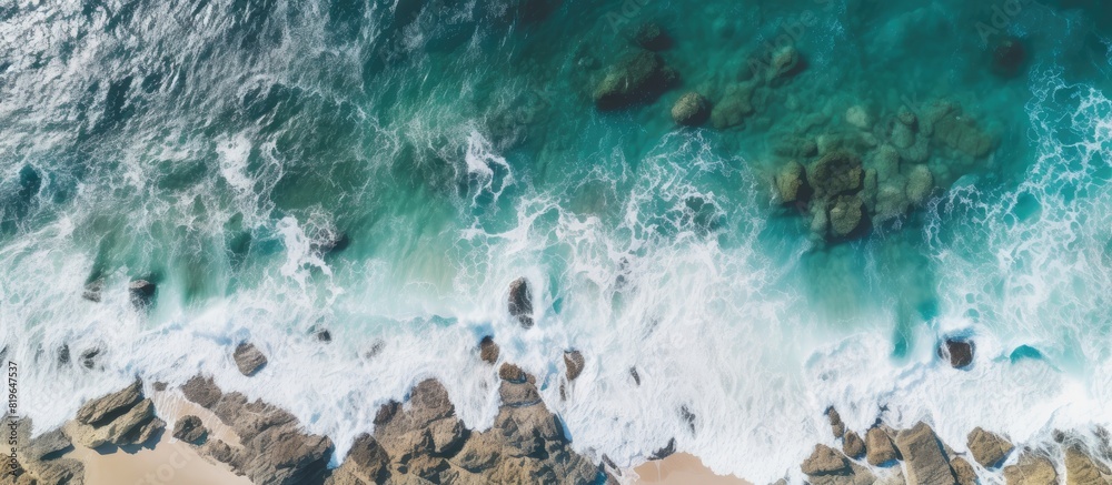 Sticker A drone captured an aerial photo of a beach with rocks and vegetation on a cloudy day revealing a panoramic view of the sea coast with copy space image