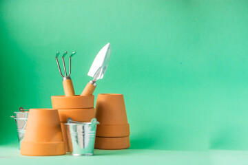 Gardening tools on a green background with copy space.