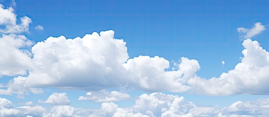Scenic view of a clear blue sky with lovely fluffy white clouds perfect for a copy space image