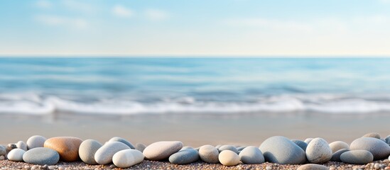 Smooth pebbles representing Zen philosophy by the seashore with a tranquil copy space image