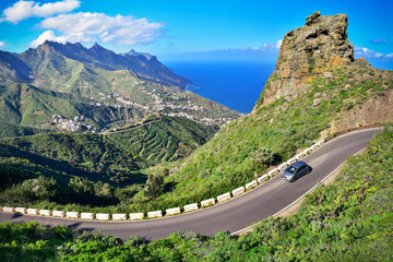 Driving car on winding road in verdant mountain landscape heading for the Atlantic Coast. Roadtrip...