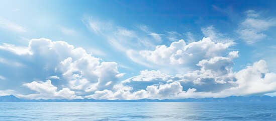 Sunny sky with clouds above a tranquil ocean with copy space image