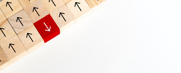 Wooden block cube reversing perspective direction arrow up opposite way thinking leadership.