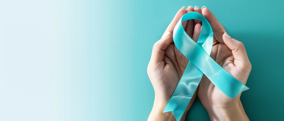A Teal blue ribbon is being held by people, symbolizing PTSD awareness, Cervical Health Awareness, Sexual Assault Awareness