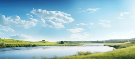 Sunny summer day featuring a river and a field with a serene landscape and copy space image