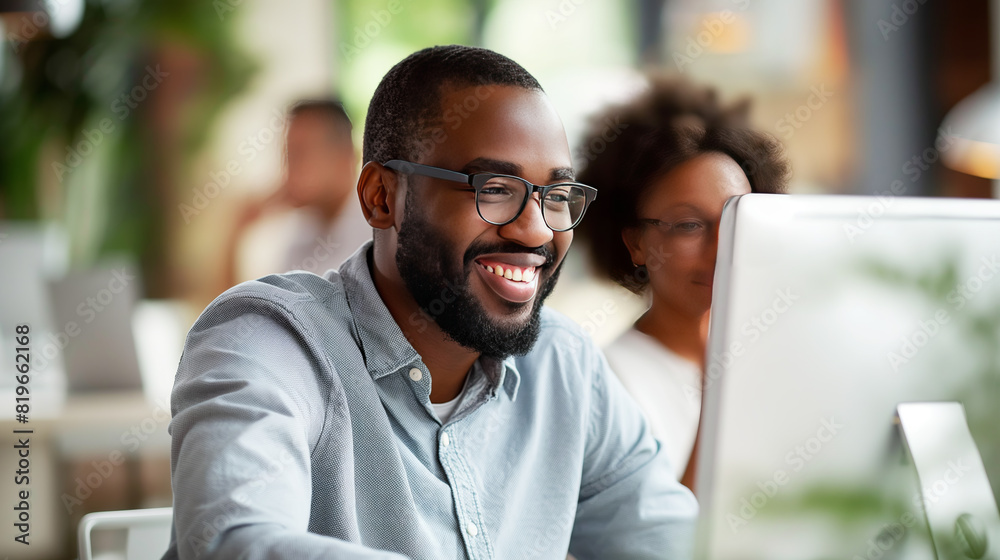 Poster smiling man with glasses using a computer, woman behind, blurred cafe background, concept of work sa