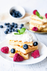 
Belgian Waffles with cream and fruit. on a wooden background. dessert