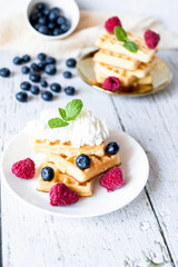 
Belgian Waffles with cream and fruit. on a wooden background. dessert