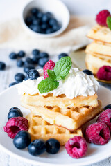 
Belgian Waffles with cream and fruit. on a wooden background. dessert