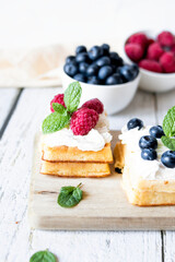 
Belgian Waffles with cream and fruit. on a wooden background. dessert