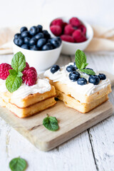 
Belgian Waffles with cream and fruit. on a wooden background. dessert