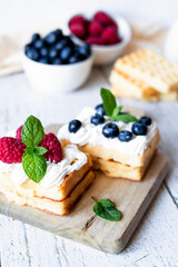 
Belgian Waffles with cream and fruit. on a wooden background. dessert