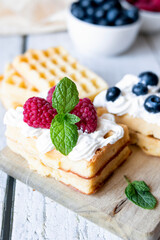 
Belgian Waffles with cream and fruit. on a wooden background. dessert