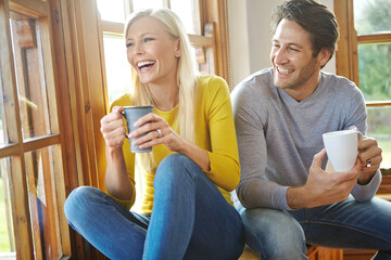 Happy couple, laughing and window with coffee for funny joke, conversation or comedy together at...