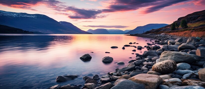 A stunning Norwegian summer landscape at a fjord beach during a vibrant sundown dusk perfect for a scenic copy space image