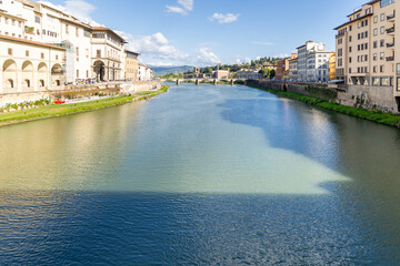 Florence, Italy - April 10, 2024: View of the Santa Trinita Bridge in Florence with tourists crowding its surroundings in Florence, Italy