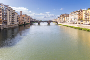 Florence, Italy - April 10, 2024: View of the Santa Trinita Bridge in Florence with tourists crowding its surroundings in Florence, Italy