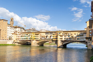 Florence, Italy - April 10, 2024: View of the Vecchio Bridge in Florence with tourists crowding its surroundings in Florence, Italy