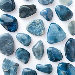 Collection of polished blue stones in various shapes on a white background, showcasing natural beauty.