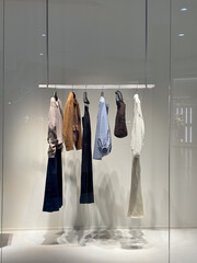 Stylish shop window with designer fashion clothes