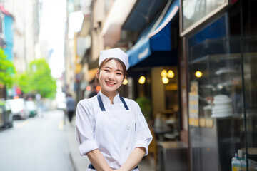 Teen pretty Japanese girl at outdoors in chef uniform