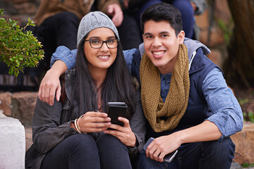 Students, couple and portrait on campus with smile, smartphones and happiness at college. Man, woman and hug at university for bonding, support and care together and sit on steps on school grounds