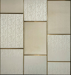 Beige and metallic ivory fabric, series of upholstered panel wall with golden brass champagne...