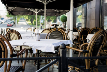 Empty cafe with terrace with tables and chairs.