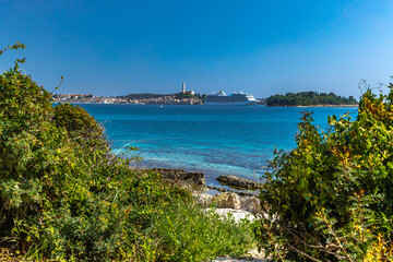 Fototapeta premium A huge tourist ship enters the port of Rovinj, sailing on the Adriatic Sea on a cruiser