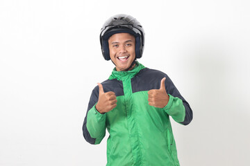 Portrait of Asian online taxi driver wearing green jacket and helmet showing good job sign, thumb...