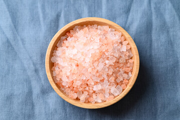 Organic Himalayan pink salt in wooden bowl, Healthy food ingredient, Top view