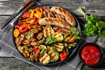 grilled white sausages with veggies and mushrooms