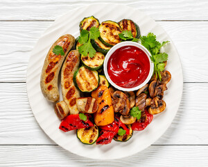 grilled white sausages with veggies and mushrooms