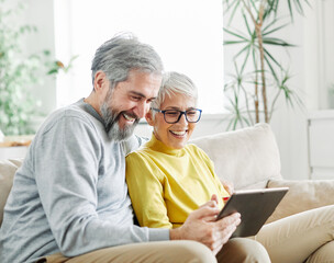 woman couple senior man happy internet love tablet together mature active elderly retirement...