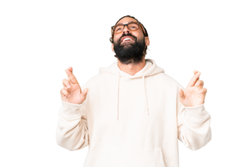 Young man with beard over isolated chroma key background with fingers crossing and wishing the best