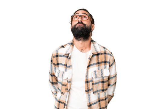 Young man with beard over isolated chroma key background and looking up