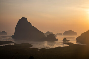 Beautiful and colorful sunrise over the sea. Large rocks in the sea. Dawn in Thailand. Colorful sky in the morning.