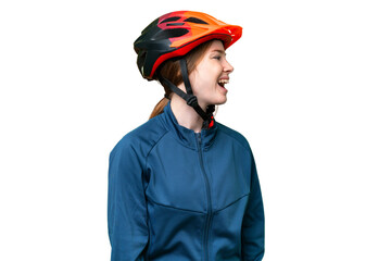 Young cyclist woman over isolated chroma key background laughing in lateral position