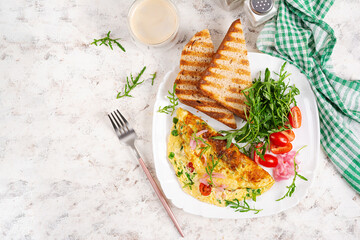 Healthy breakfast. Omelette with cheese, tomatoes   and green herbs. Omelette, salad and toast. Keto, ketogenic lunch. Top view, above