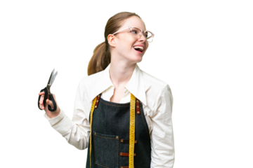 Seamstress woman over isolated chroma key background laughing in lateral position