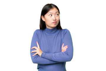 Young Asian woman over isolated chroma key background making doubts gesture while lifting the shoulders