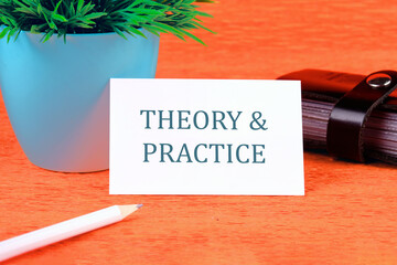 Business, theory and practice concept. Copy space. Theory and practice symbol on a business card in...