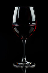 Glass with red wine on a black background