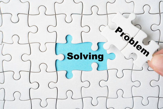 Hand holding problem wording on jigsaw and assemble to solving wording for creative thinking idea solution concept.