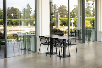 Modern outdoor terrace with seating arrangement. Fashionable outdoor cafe or restaurant tables, summer time