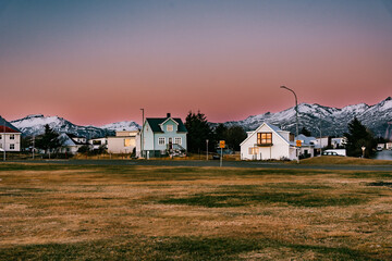 Little village with typical Nordic houses in the southern of Iceland with mountains and snow