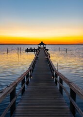 Fototapeta premium Dock leading out to a bay at sunset in the Outer Banks of North Carolina