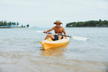 Happy Asian Man Paddling Kayak on Tropical Beach - Summer Vacation Adventure