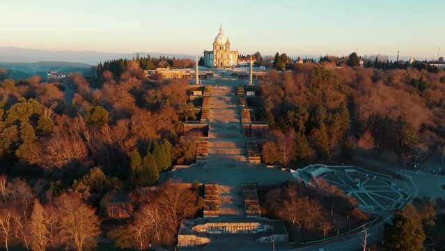 Aerial footage of the Sanctuary of Our Lady of Sameiro at sunset with autumn trees in Braga